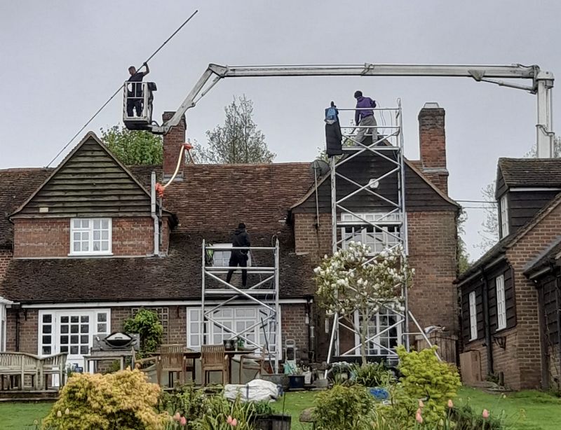 The Moss Cleaners using cherry picker and scaffolding to clean roof safely and professionally in Stonehouse, Gloucestershire